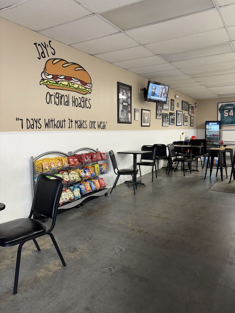 Interior of Jay's Original Hoagies with framed sports photos and memorabilia on the wall